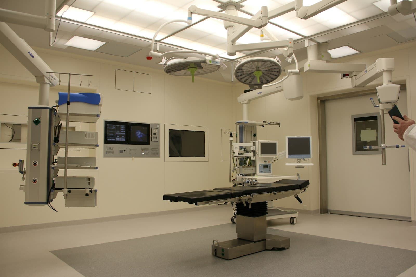 Modern hospital operating room with surgical lights and monitoring devices
