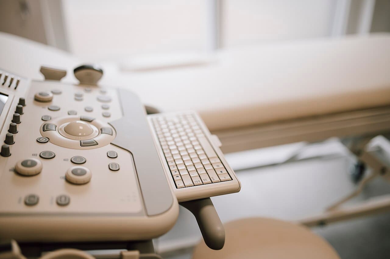 Ultrasound machine control panel in a clean medical room